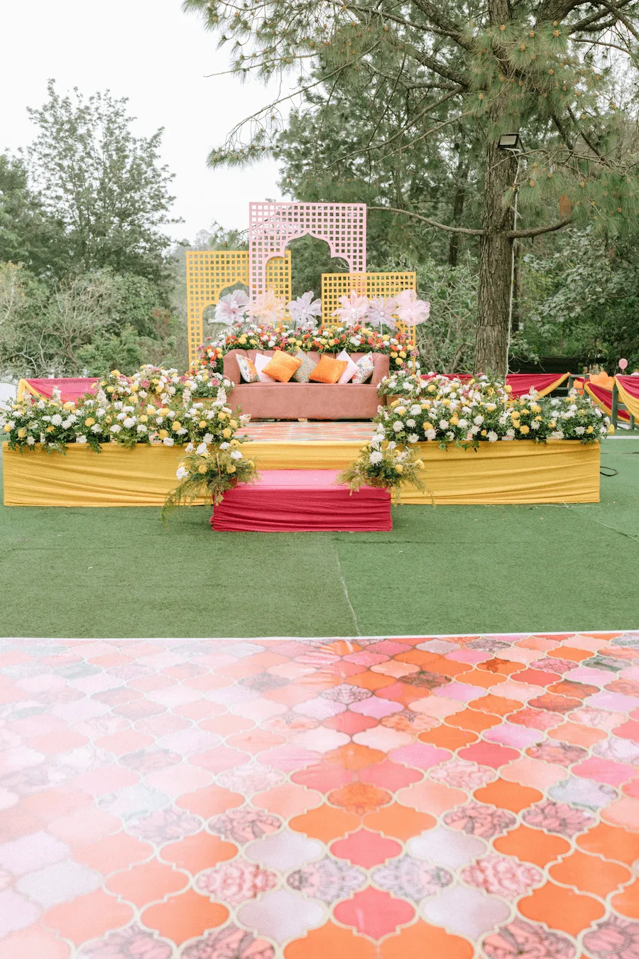 Outdoor wedding stage decoration with flowers and drapes